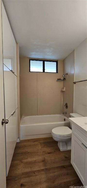 full bathroom with vanity, wood-type flooring, shower / tub combination, and toilet