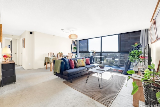 living room featuring light carpet and a wall of windows