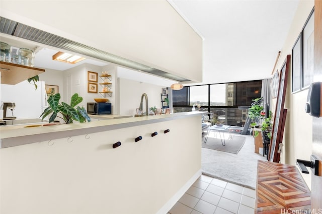 kitchen featuring light tile patterned flooring and sink