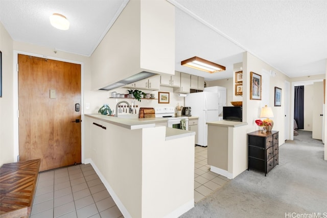 kitchen with white cabinetry, light tile patterned floors, white appliances, kitchen peninsula, and a textured ceiling