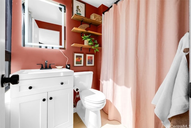 bathroom featuring vanity, tile patterned floors, and toilet