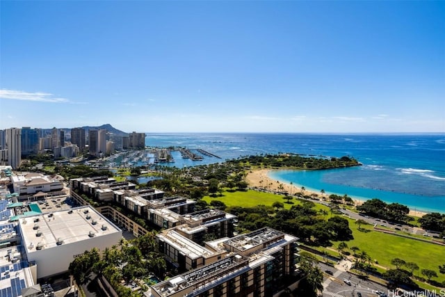 drone / aerial view featuring a water view and a view of the beach