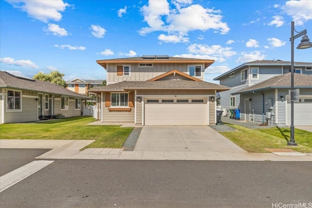 view of front of property with a garage, a front yard, and solar panels