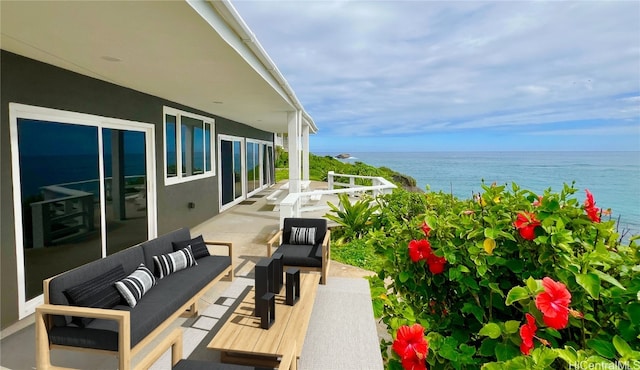 balcony with a water view and an outdoor living space