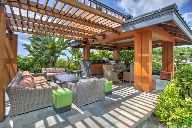 view of patio with an outdoor kitchen, an outdoor living space, a pergola, and an outdoor bar