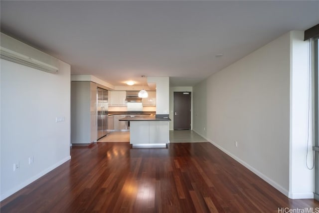 unfurnished living room with dark hardwood / wood-style flooring