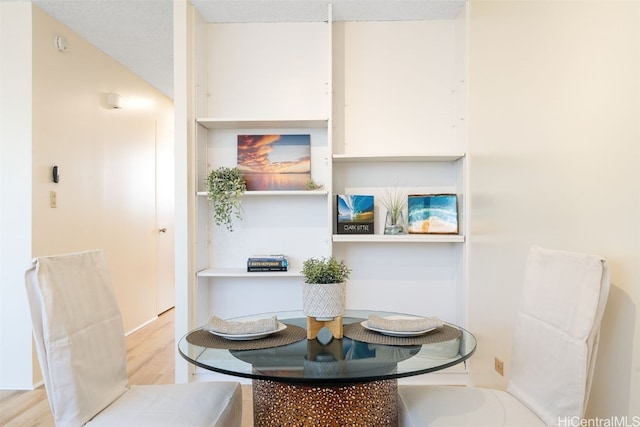 dining room featuring breakfast area and light hardwood / wood-style floors