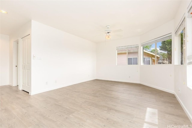 empty room featuring ceiling fan and light hardwood / wood-style floors