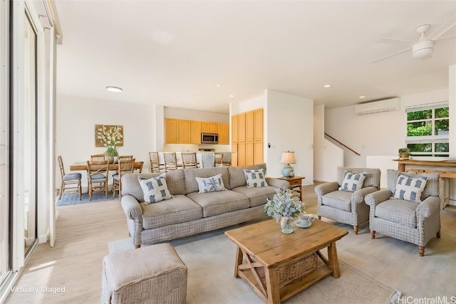 living room featuring light wood-type flooring and an AC wall unit