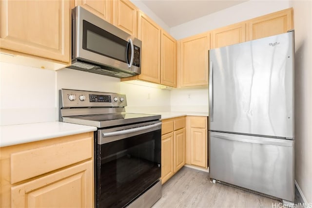 kitchen featuring stainless steel appliances, light brown cabinets, and light hardwood / wood-style flooring