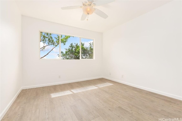 spare room with ceiling fan and light wood-type flooring