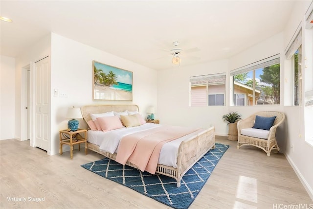 bedroom with wood-type flooring and ceiling fan