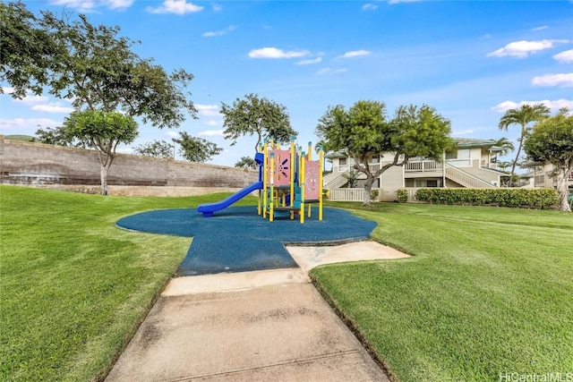 view of jungle gym featuring a lawn