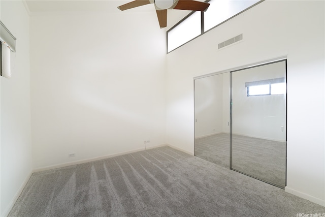 500 Lunalilo Home Rd Unit 28G, Honolulu, HI 96825 - unfurnished bedroom with carpet floors, visible vents, a closet, a towering ceiling, and baseboards