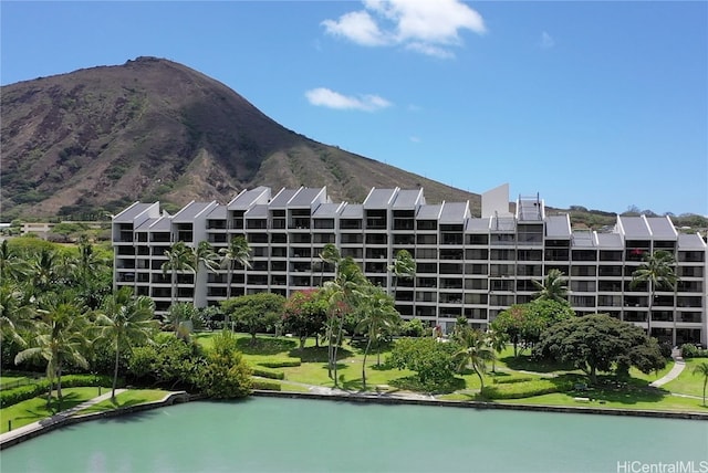 exterior space with a water and mountain view