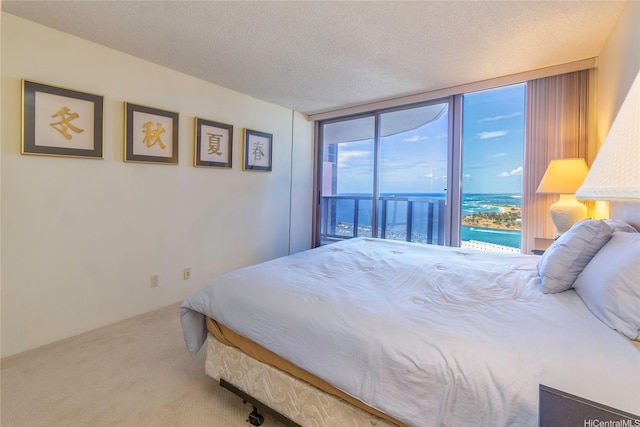 425 S St Unit 3601, Honolulu, HI 96813 - carpeted bedroom with access to outside, a water view, a wall of windows, and a textured ceiling
