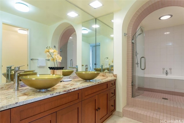 bathroom featuring tile patterned floors, vanity, and independent shower and bath