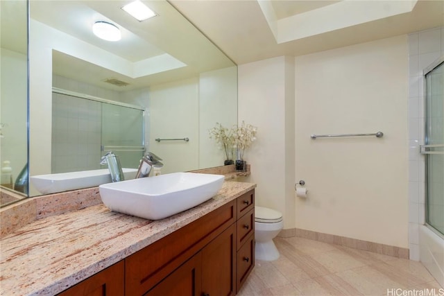 full bathroom with vanity, enclosed tub / shower combo, and toilet