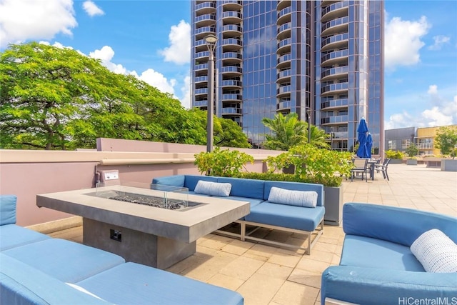 view of patio featuring an outdoor living space with a fire pit