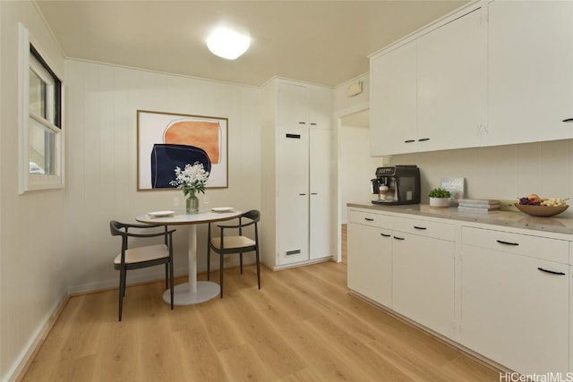 kitchen with white cabinetry and light hardwood / wood-style flooring