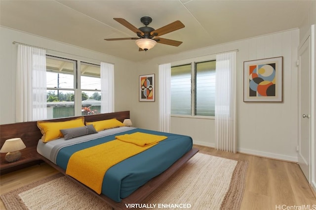 bedroom with ceiling fan and light wood-type flooring