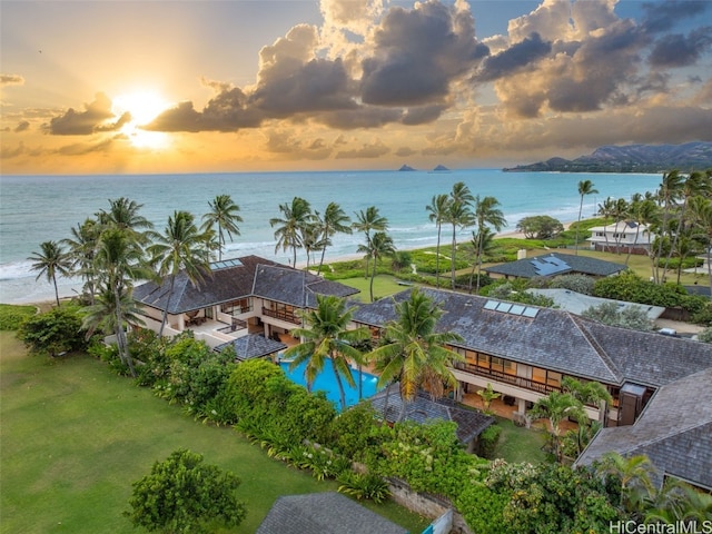 aerial view at dusk featuring a water view