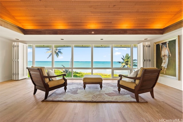 sitting room featuring vaulted ceiling, a water view, and wooden ceiling