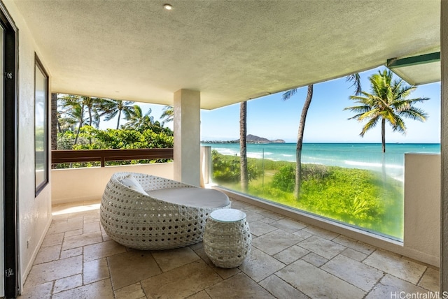 sunroom / solarium featuring a water view