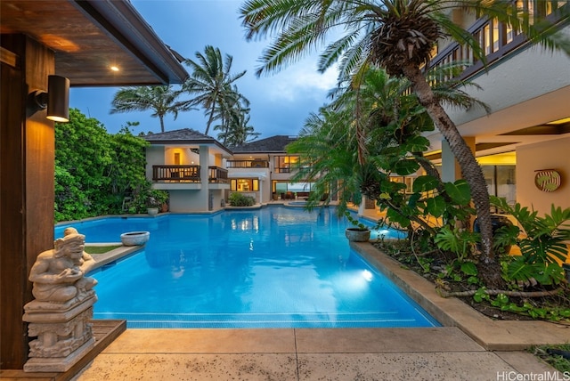 view of pool at dusk