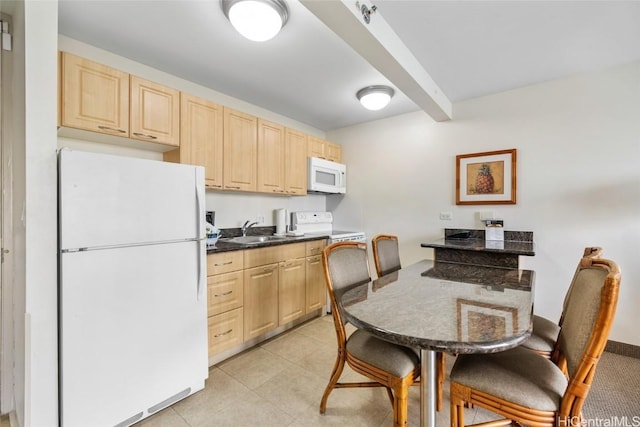 kitchen with light tile patterned flooring, sink, light brown cabinets, beamed ceiling, and white appliances