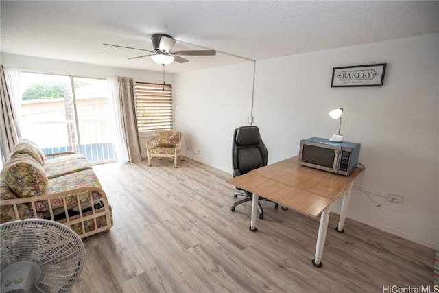 home office with hardwood / wood-style floors, a textured ceiling, and ceiling fan