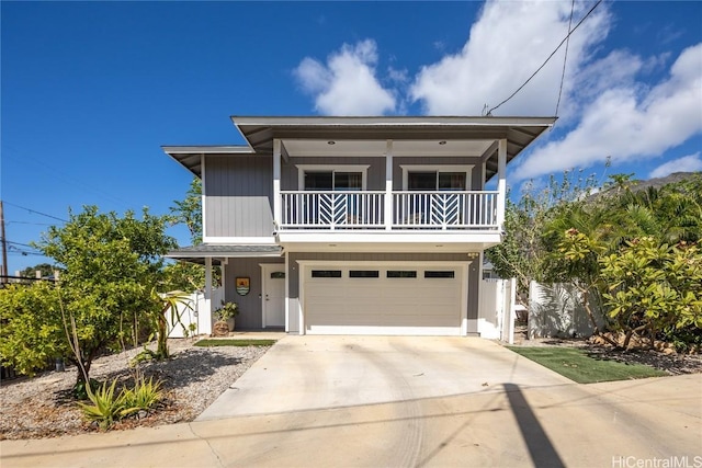 view of front of property featuring a balcony and a garage