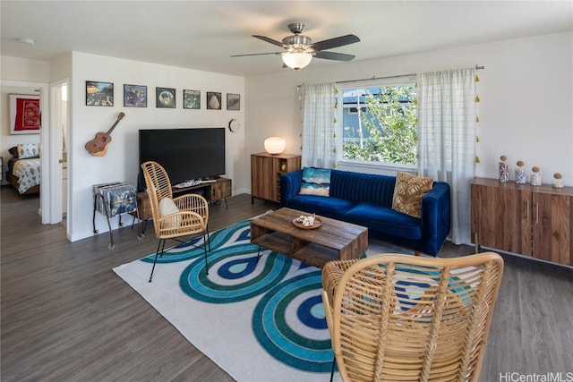 living room with dark hardwood / wood-style flooring and ceiling fan