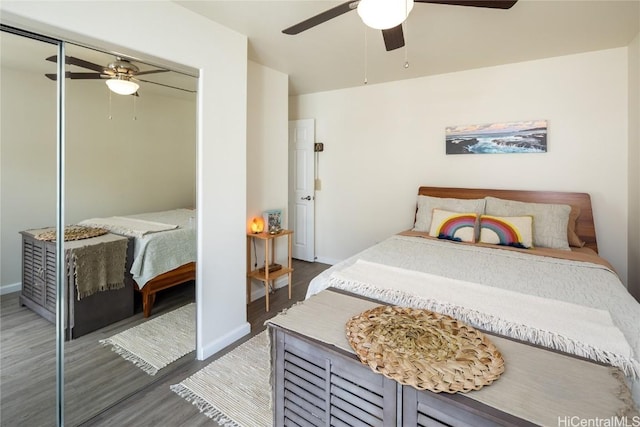 bedroom with a closet, dark hardwood / wood-style floors, and ceiling fan