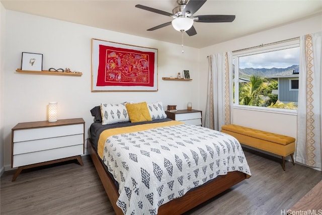 bedroom with dark hardwood / wood-style floors and ceiling fan