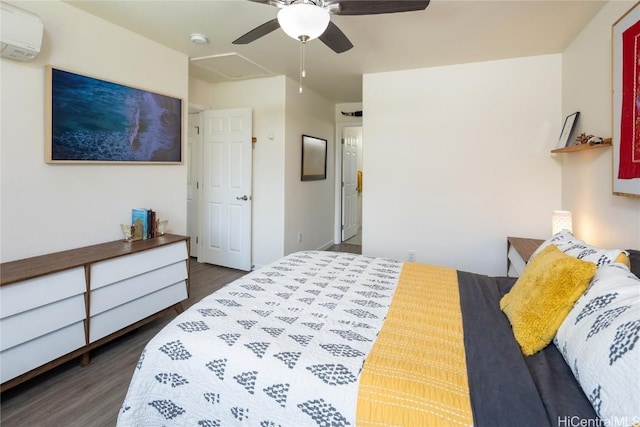 bedroom featuring dark wood-type flooring, a wall unit AC, and ceiling fan