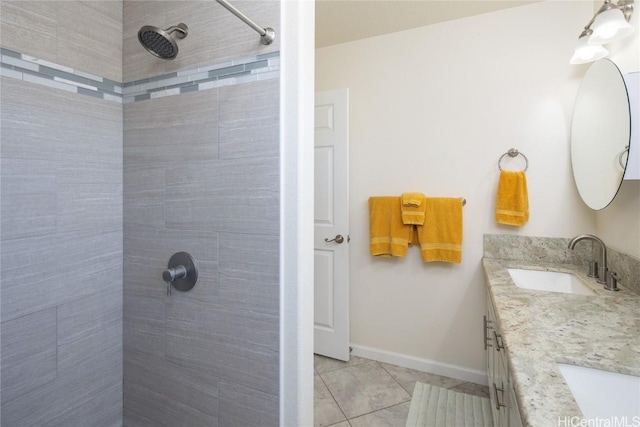 bathroom featuring tiled shower and vanity