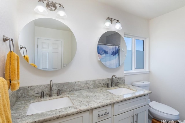 bathroom featuring vanity, toilet, and a shower with shower curtain