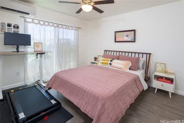 bedroom with ceiling fan, a wall mounted air conditioner, and dark hardwood / wood-style flooring