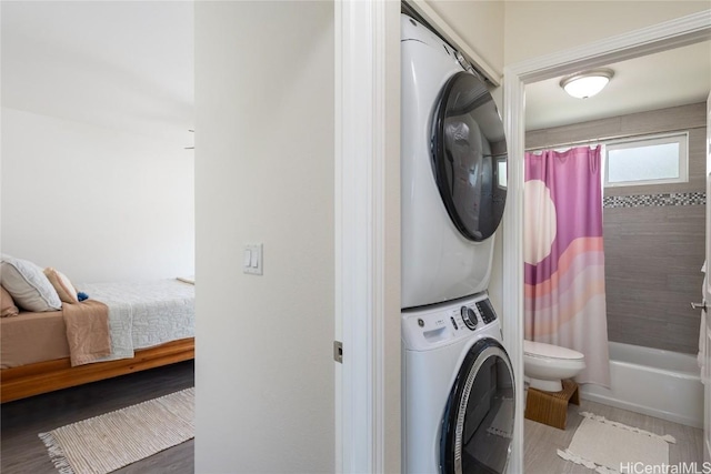 laundry room with stacked washing maching and dryer