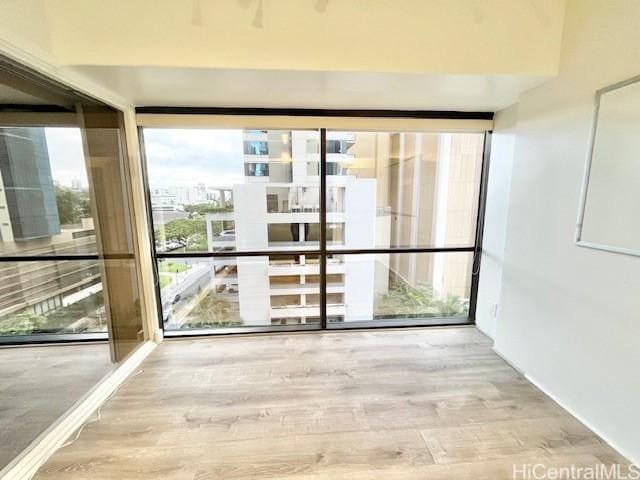 entryway with hardwood / wood-style floors and a wall of windows