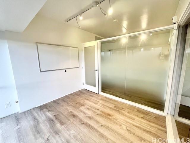 interior space featuring track lighting and light wood-type flooring