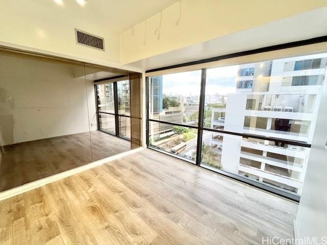 spare room with wood-type flooring