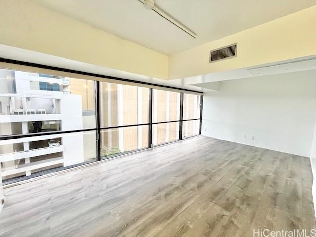 spare room featuring hardwood / wood-style floors