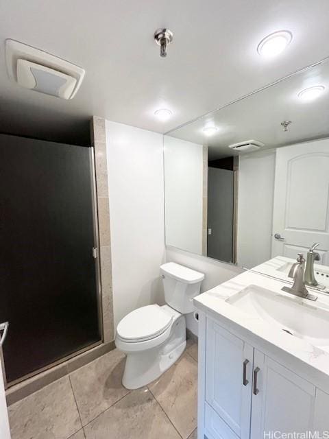 bathroom with vanity, toilet, and a shower with shower door