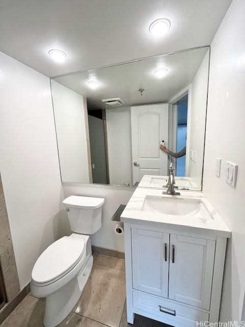 bathroom featuring vanity and toilet