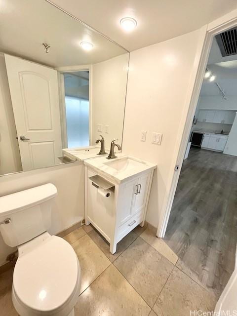 bathroom with vanity, tile patterned flooring, and toilet