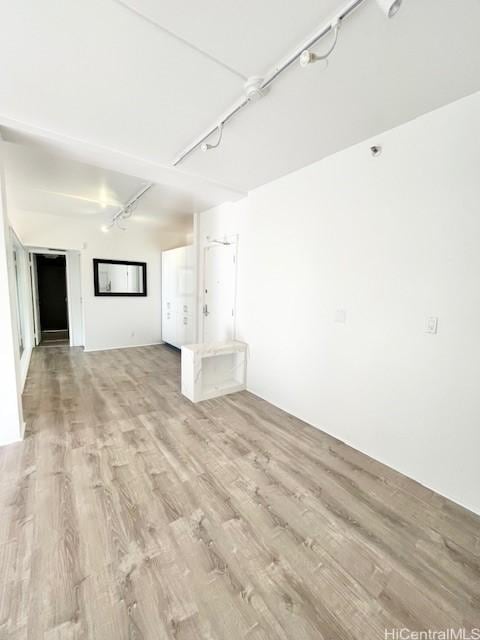 interior space featuring track lighting and light hardwood / wood-style floors