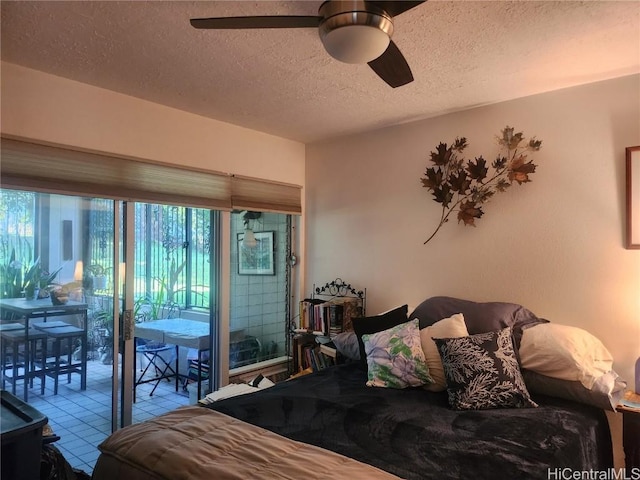 tiled bedroom featuring access to outside, a ceiling fan, and a textured ceiling