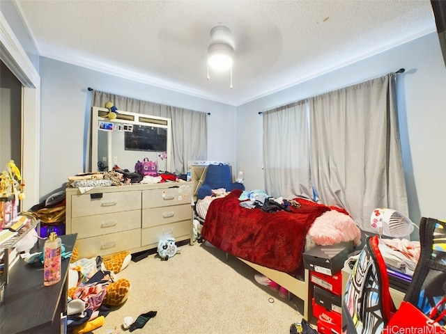 bedroom with ceiling fan, carpet floors, and a textured ceiling